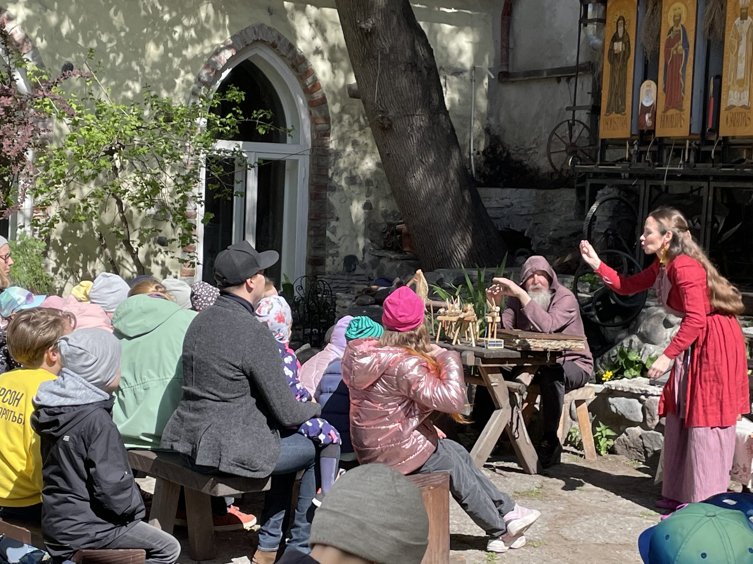 A woman telling a story to an audience at a storytelling festival.