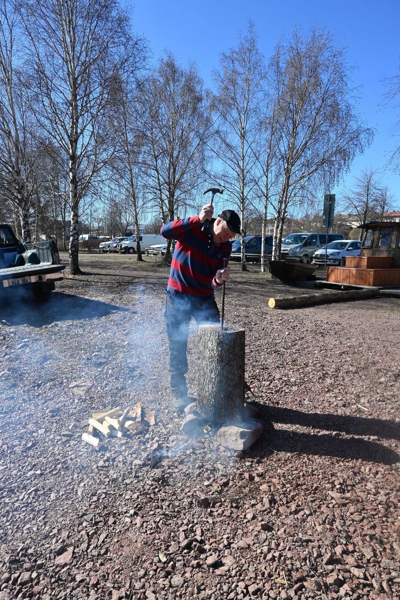 A person working on a birdhouse.