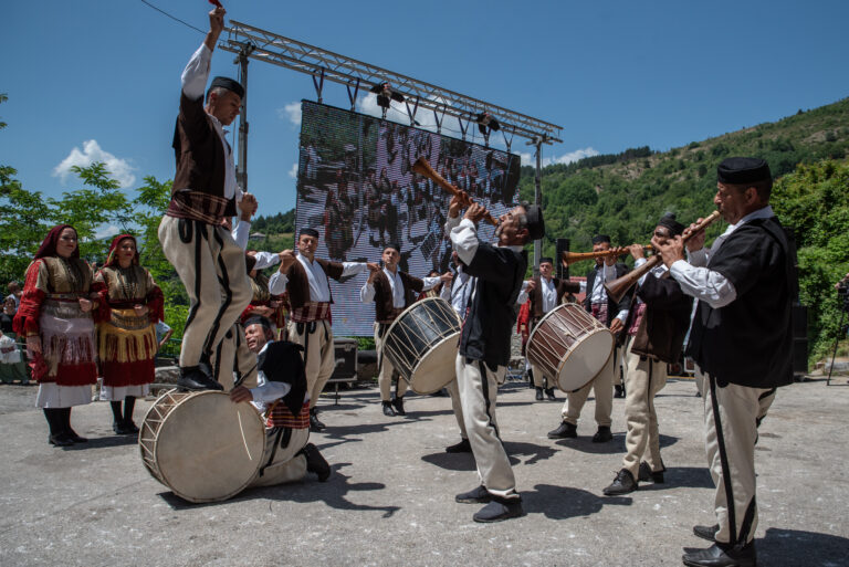 This image depicts people performing a traditional Macedonian dance known as Teshkoto